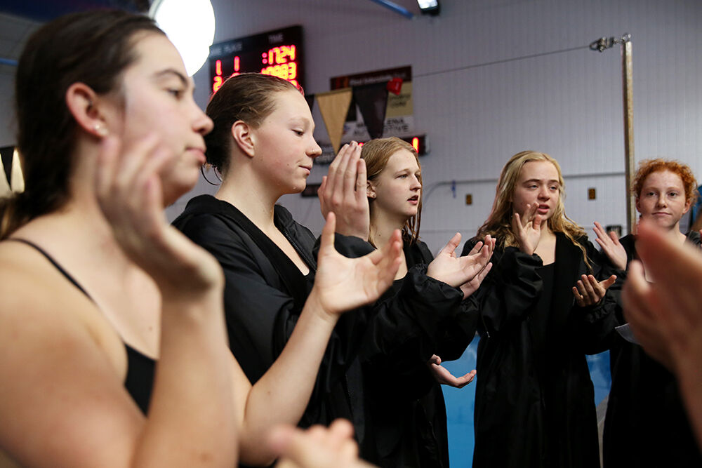 The BHS girls swim team huddled together for their chant